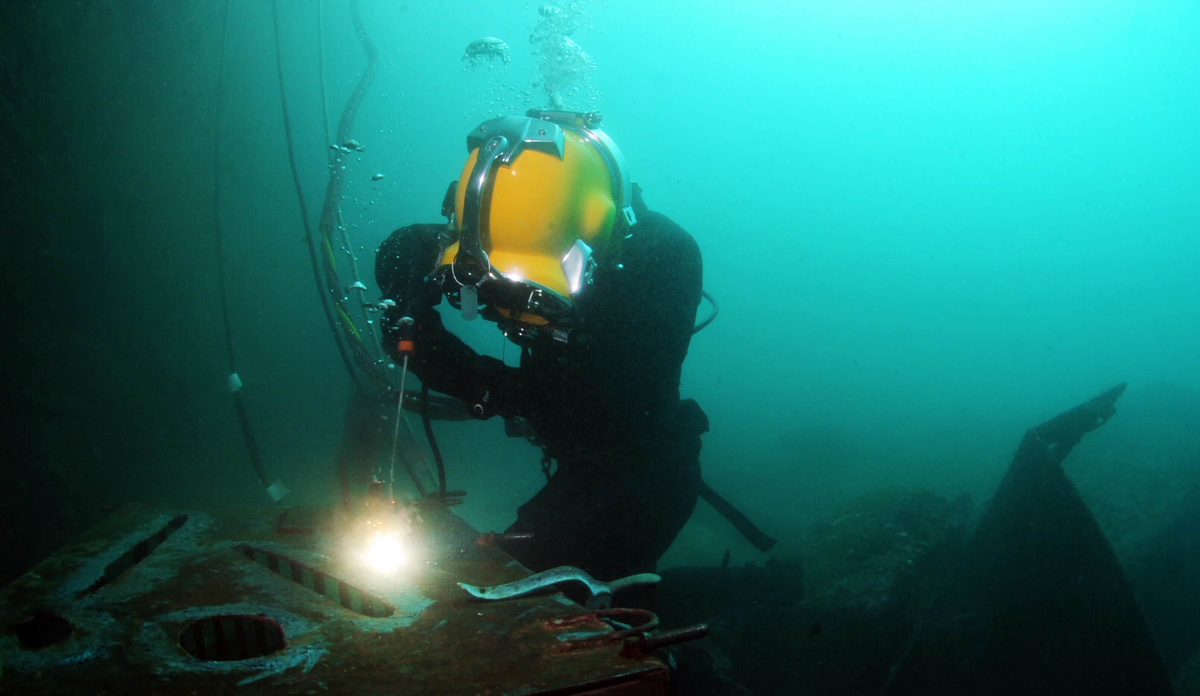Commercial diver carrying out underwater welding work